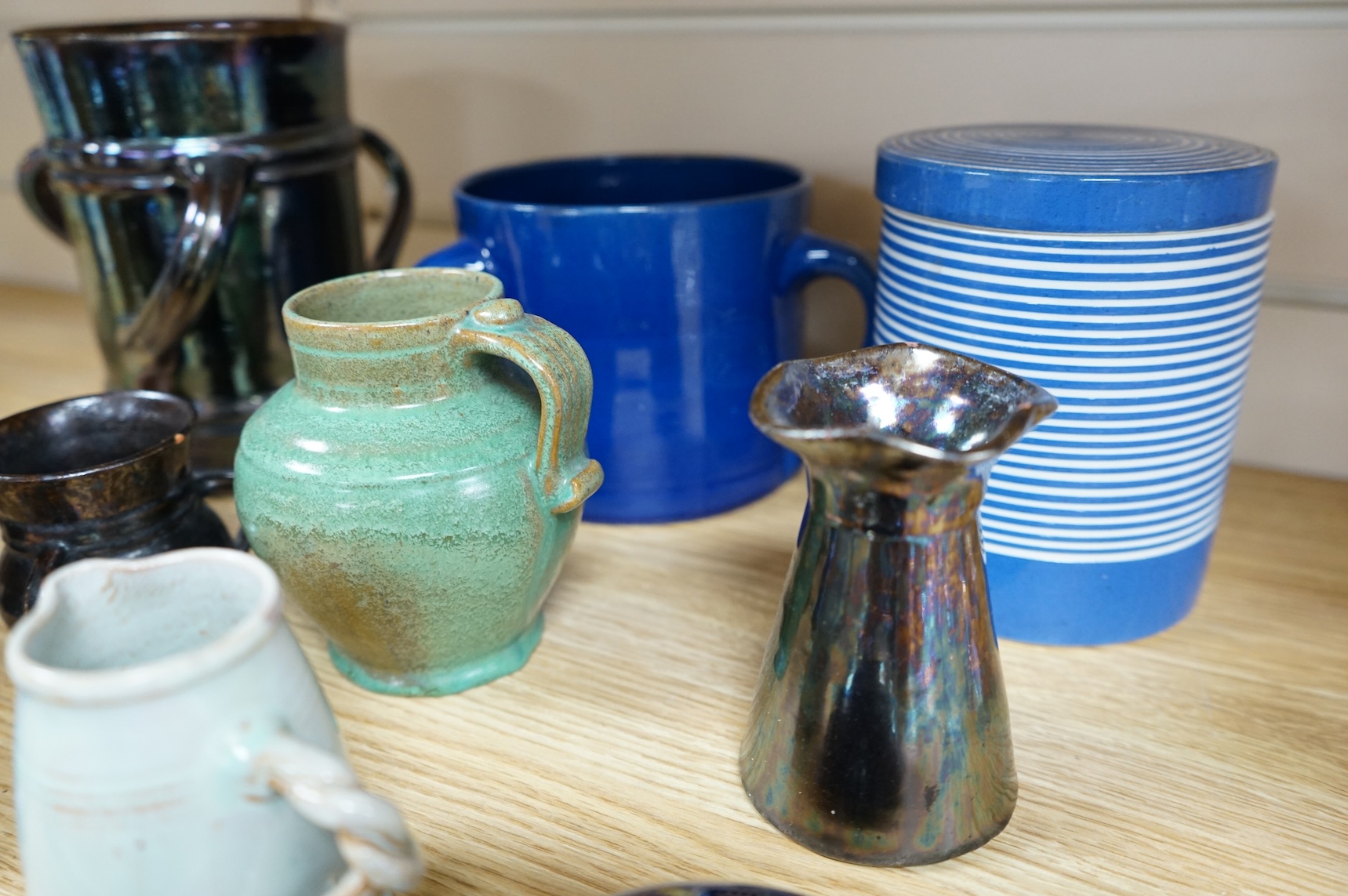 A collection of pottery to include lustre glazed jugs and tygs, a T. G. Green storage jar, Carltonware ash tray and a miniature Ruskin style vase, largest 18cm high